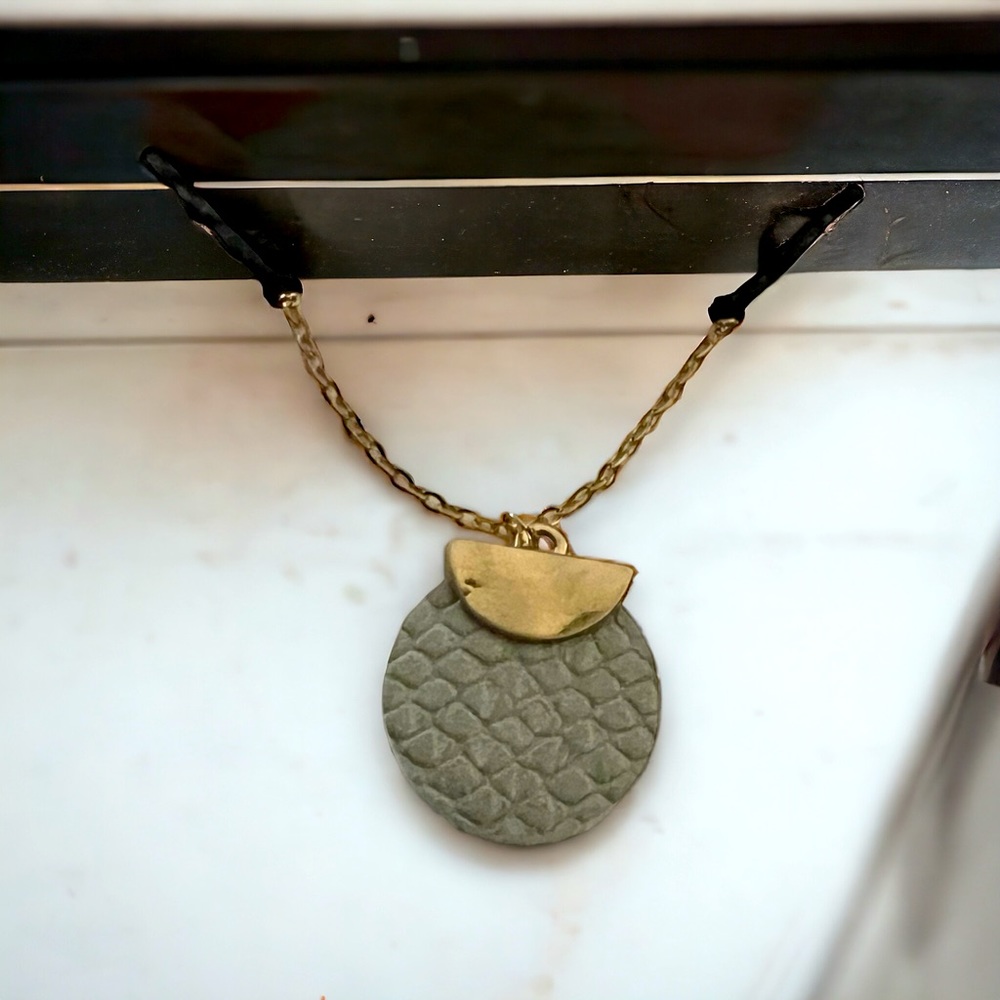 Necklace- simple gold chain with round gray leather charm